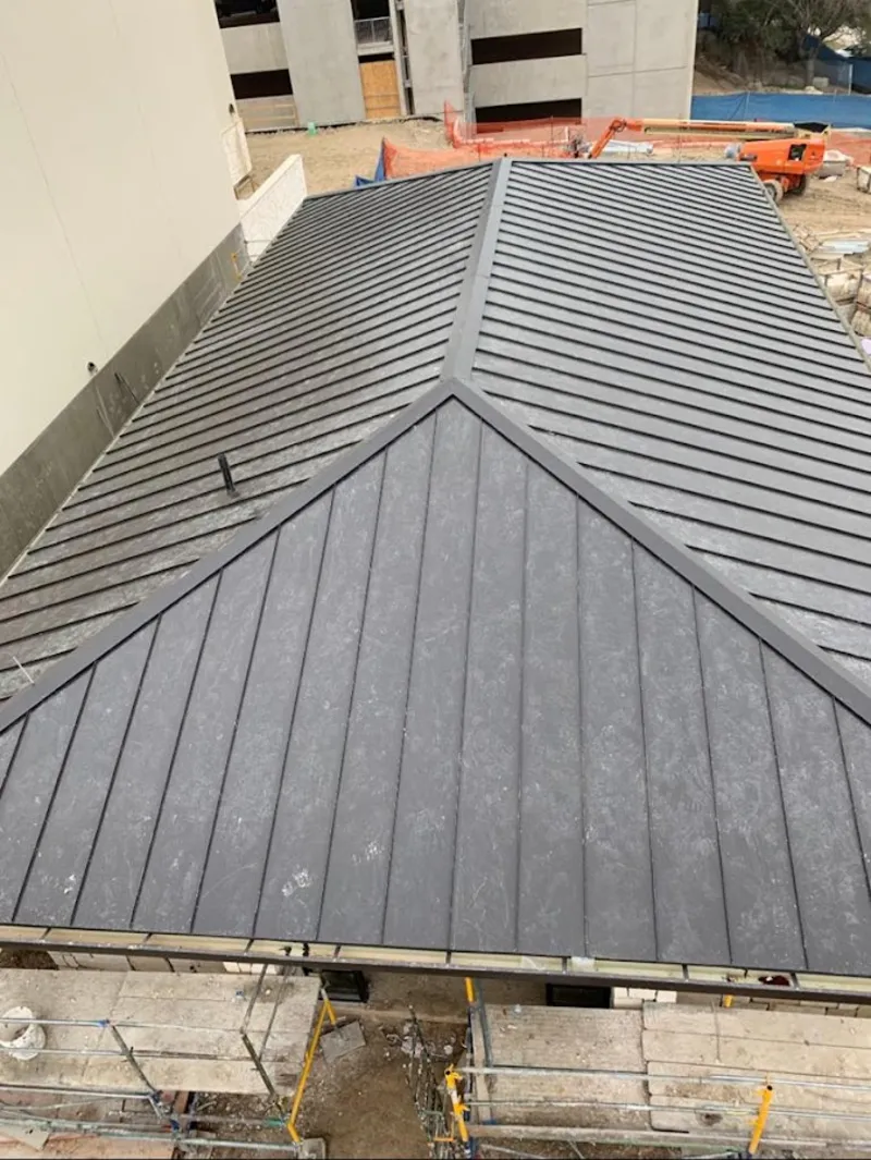 Commercial metal roof construction with crane equipment in Hatboro